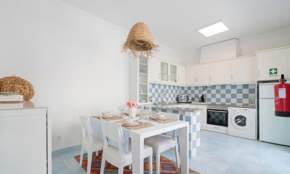 Dining area with table for 4, oven, washing machine and fridge
