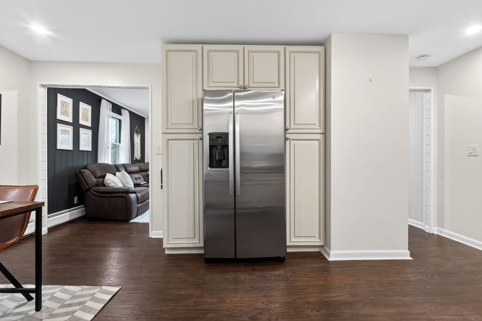 Bright modern kitchen with stainless steel appliances, warm cabinetry, and a welcoming island set for cooking and conversation.