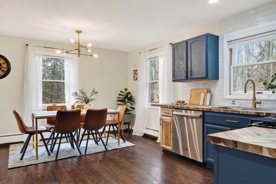 Warm, modern kitchen and dining space with natural light and stylish finishes. (The Hollow)