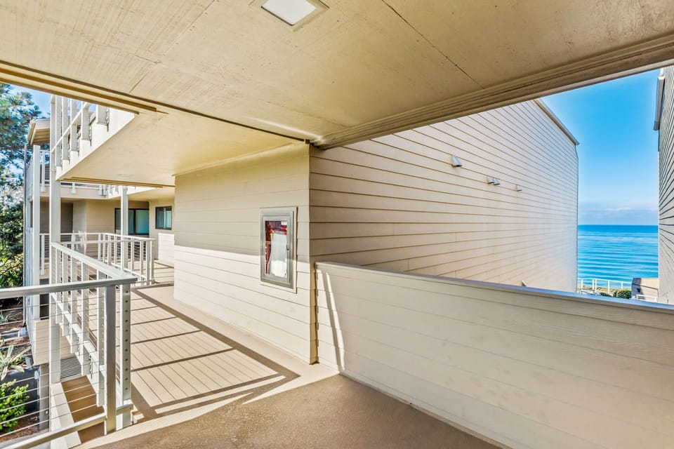 Covered outdoor walkway with a view toward the water.