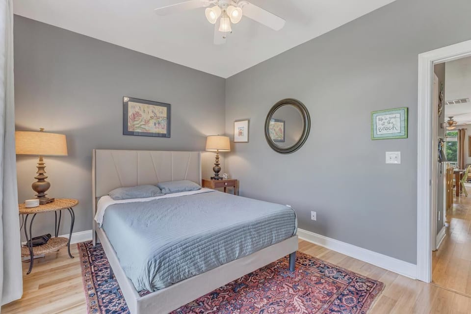 Rest peacefully in your serene bedroom with soft gray walls, cozy lighting, and thoughtful coastal touches that create the perfect retreat.