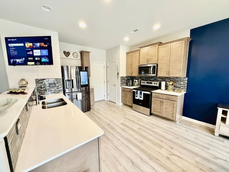 Modern kitchen with spacious island, stainless appliances, and open layout.