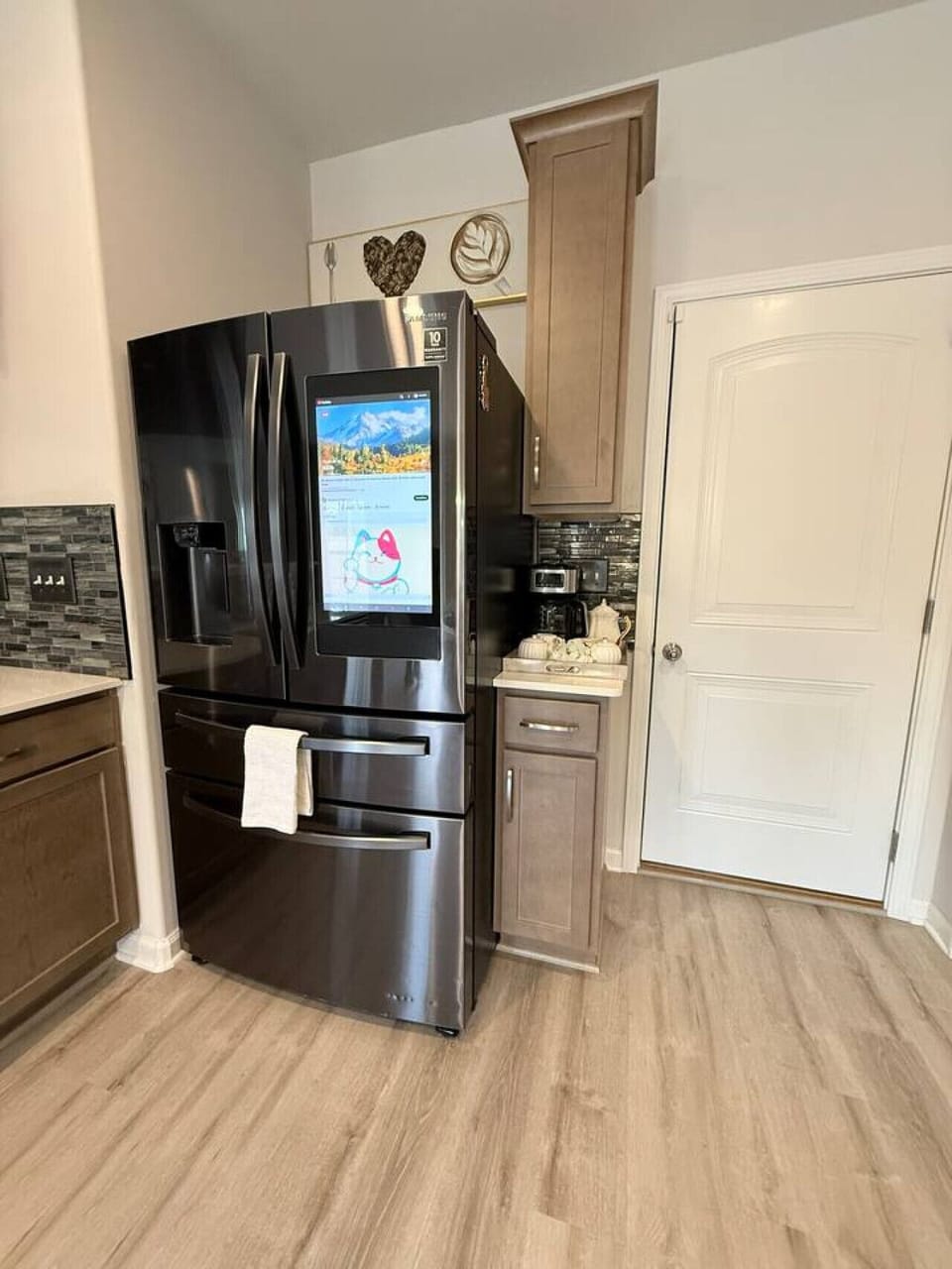 Modern stainless steel refrigerator with spacious storage in bright kitchen.