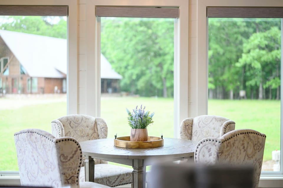 Settle into elegant chairs around your private dining table, where fresh lavender and peaceful garden views create the perfect spot for morning coffee or intimate meals.