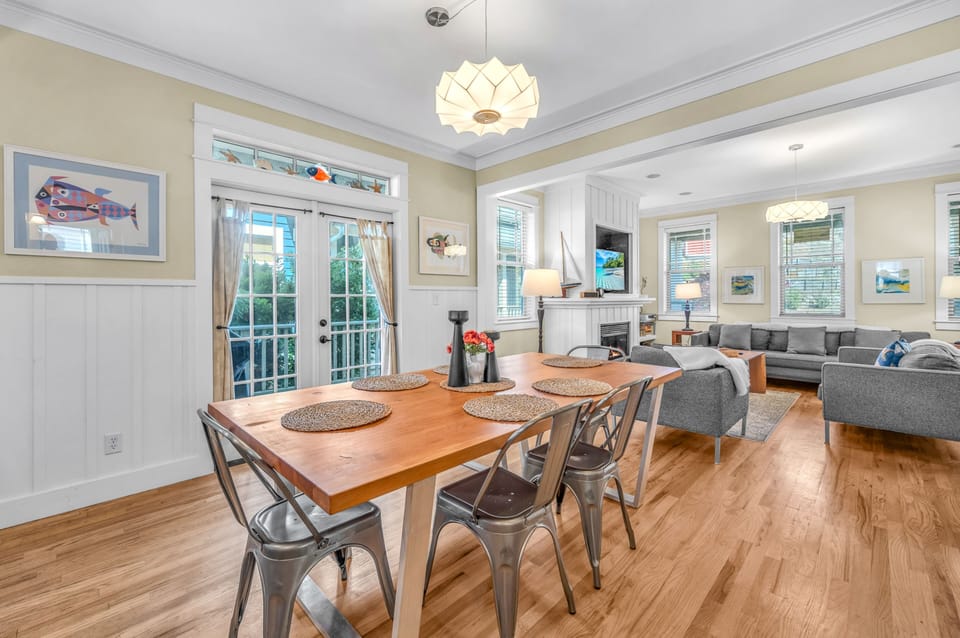 Gather around your spacious dining table while natural light flows through French doors, creating the perfect backdrop for memorable meals together.