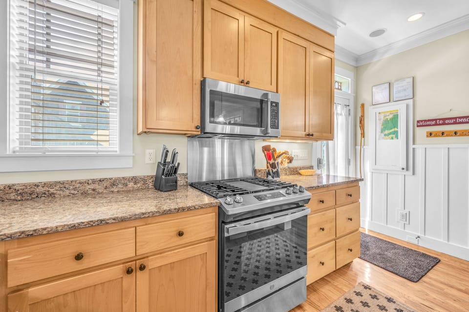 Your fully equipped kitchen offers everything needed to prepare meals, from granite countertops to stainless steel appliances and warm wood cabinetry.