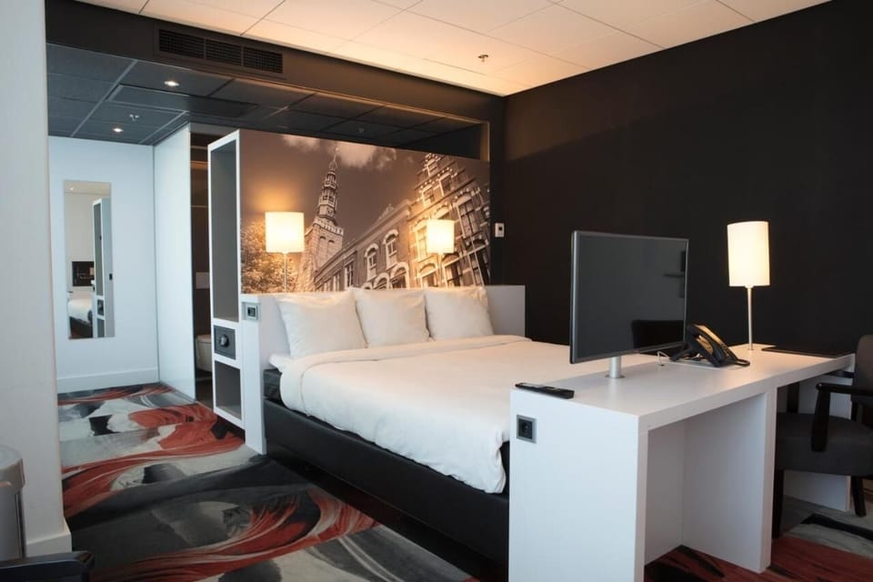 Sink into a plush bed framed by dramatic city-inspired art.