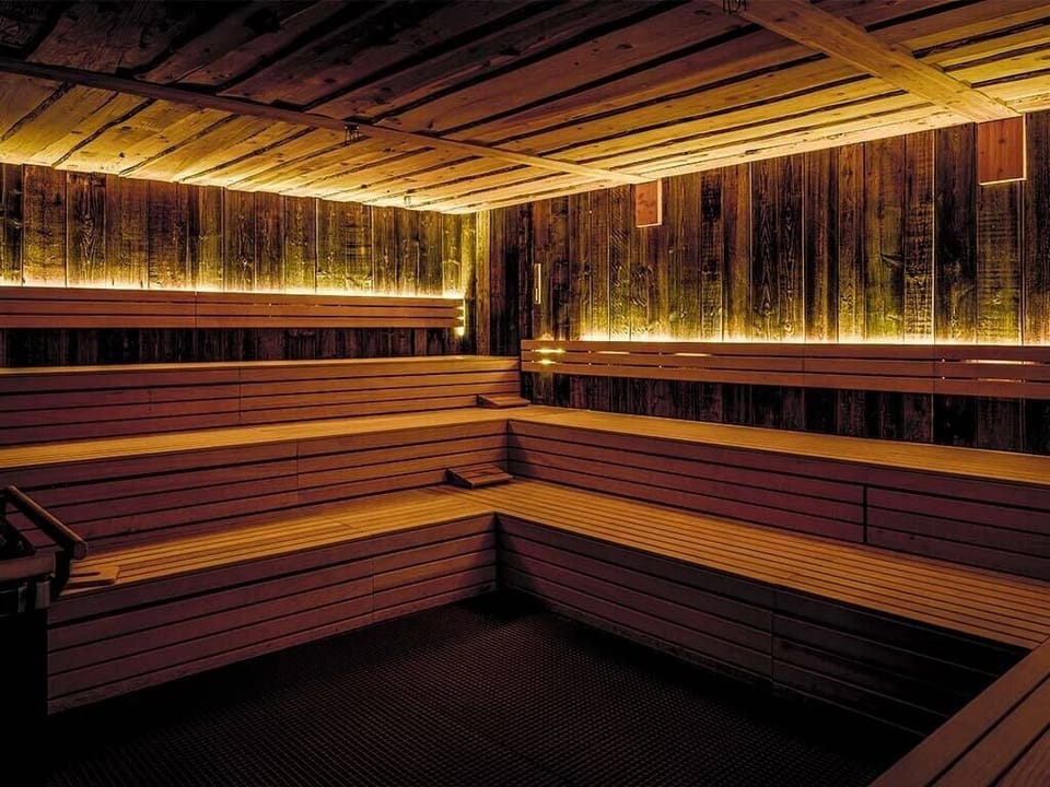 Sink into deep heat in this intimate timber sauna.
