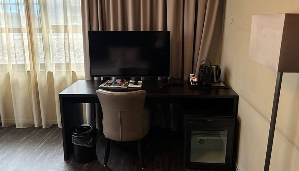 Catch up on work at the desk with entertainment nearby