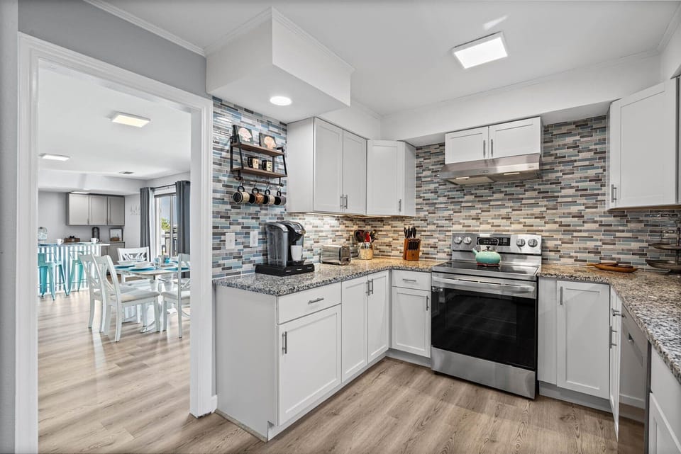 Your sleek kitchen features modern appliances and a stunning tile backsplash, perfect for creating memorable meals during your stay.