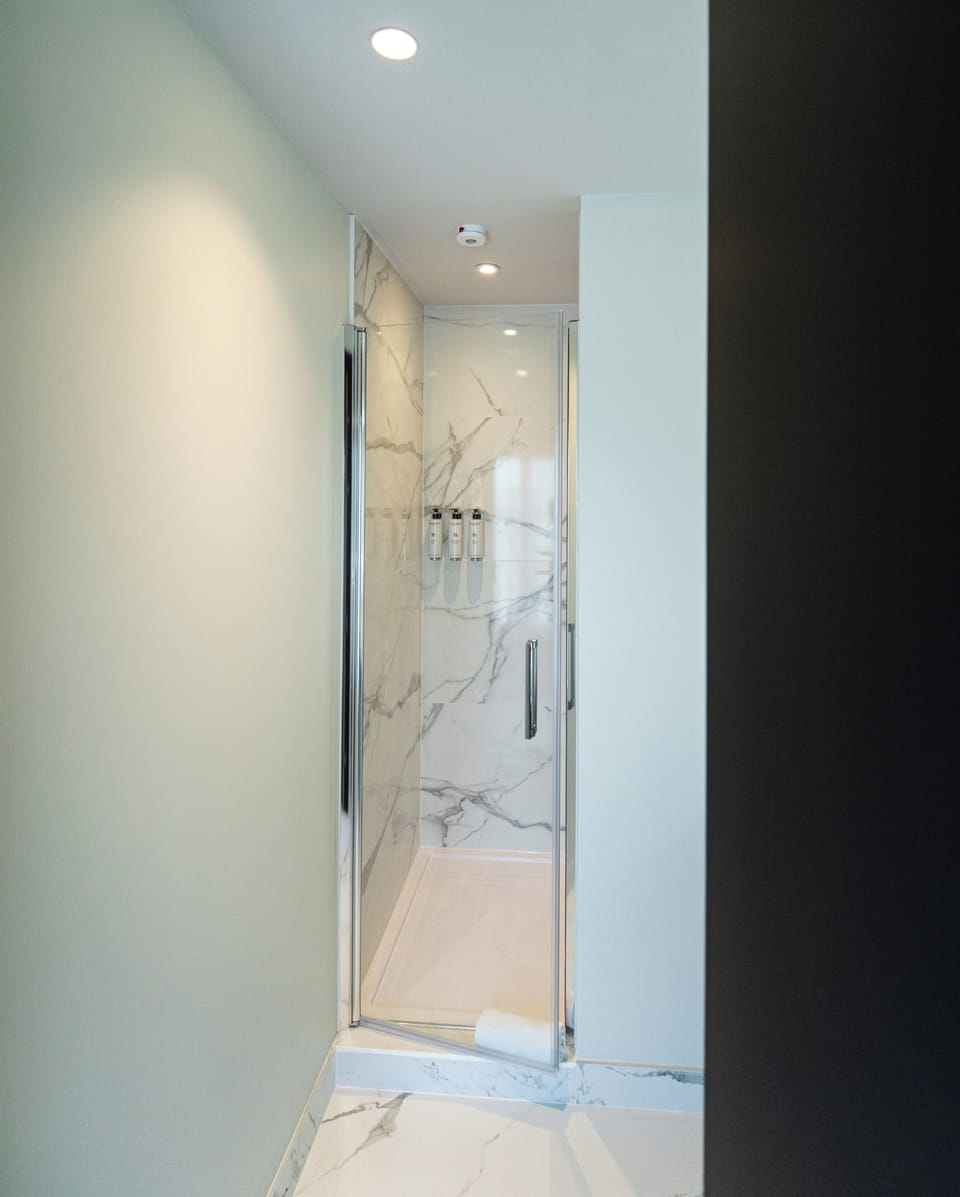 Shower, rainfall showerhead, hair dryer, towels