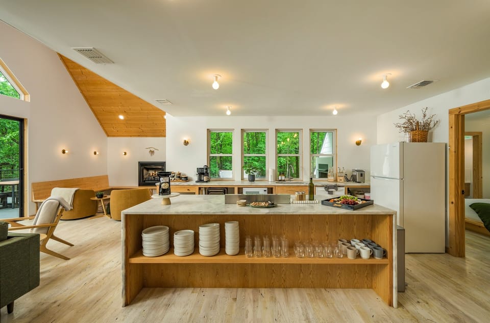 Open Concept Kitchen: Modern design meets nature with lush views and a spacious entertaining area!