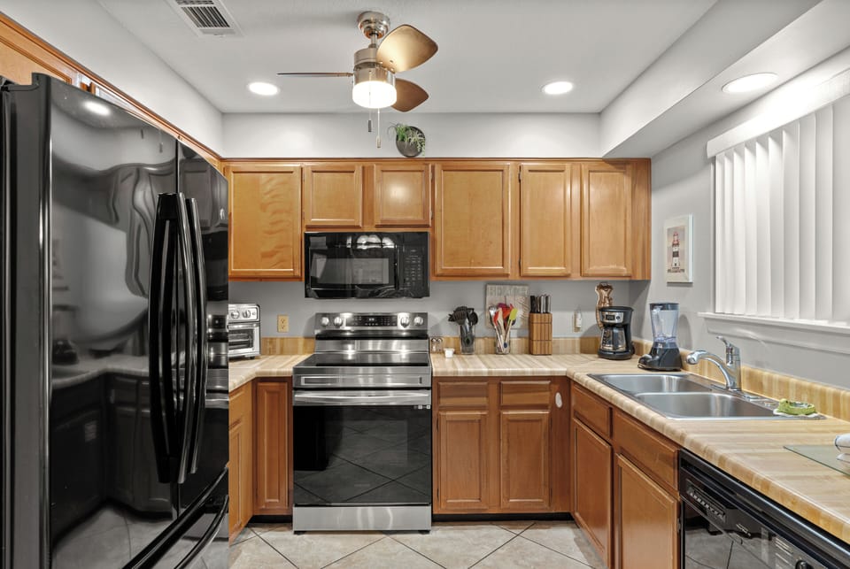 The fully equipped kitchen features stainless steel appliances