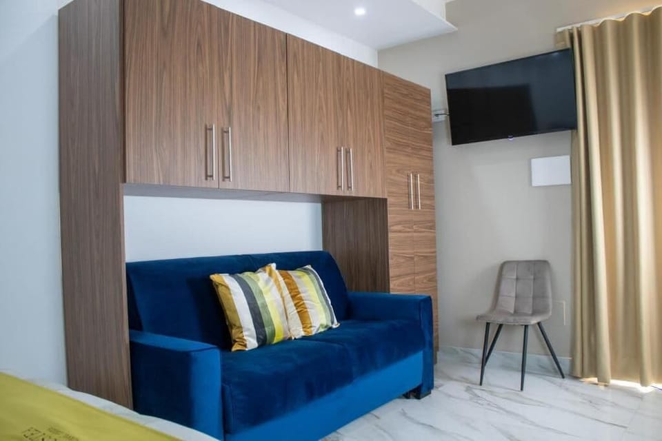 Deluxe Double Room, Balcony, Garden View | Living area | TV