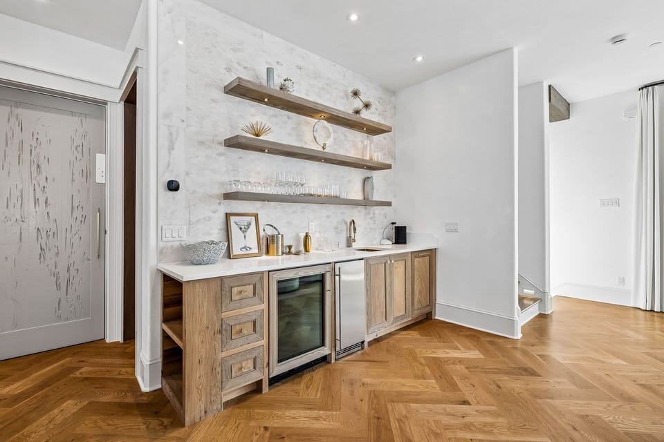 Your private bar area with rustic wood shelving and chilled beverage storage makes entertaining effortless—ideal for mixing drinks or enjoying a quiet evening at home.