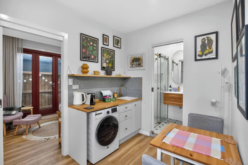 Enjoy simple meal prep in the kitchenette, complete with a sink, kettle, and coffee machine, plus a mini fridge, microwave, and stove tucked away in the cupboard.