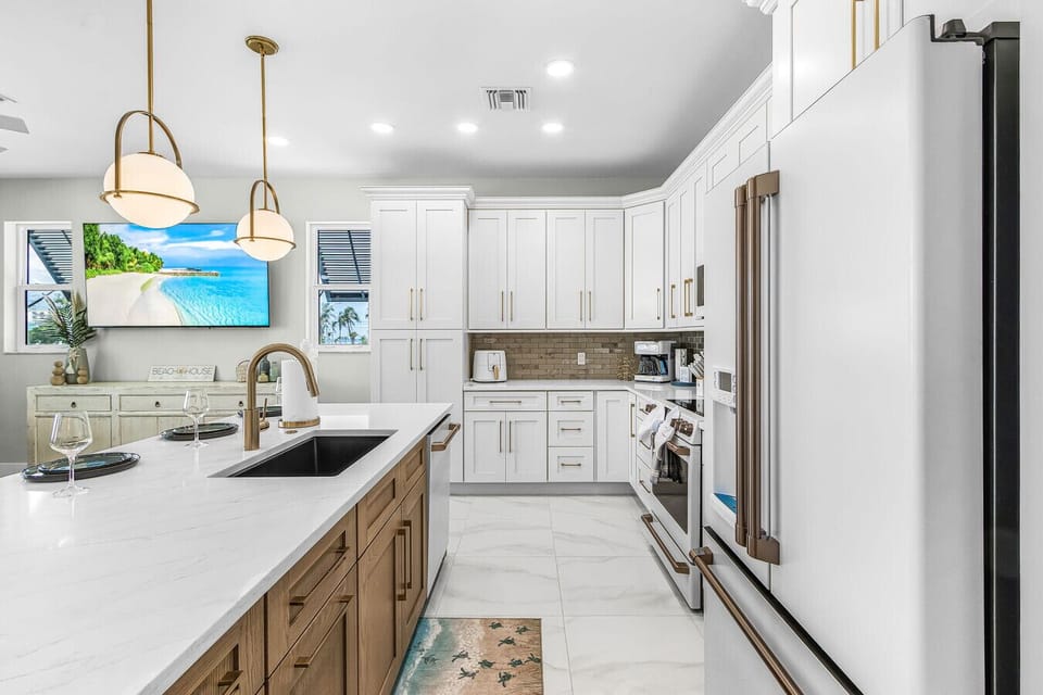 A kitchen designed for both cooking and gathering. Enjoy ample quartz counter space, a deep under-mount sink, and convenient small appliances—including an air fryer—to make meal prep a breeze.