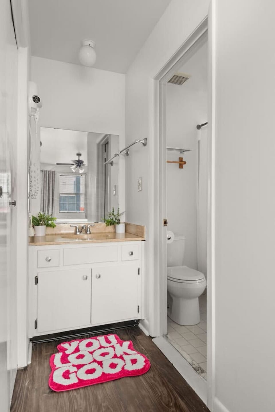 Bright bathroom featuring crisp white cabinetry and a comfortable layout.