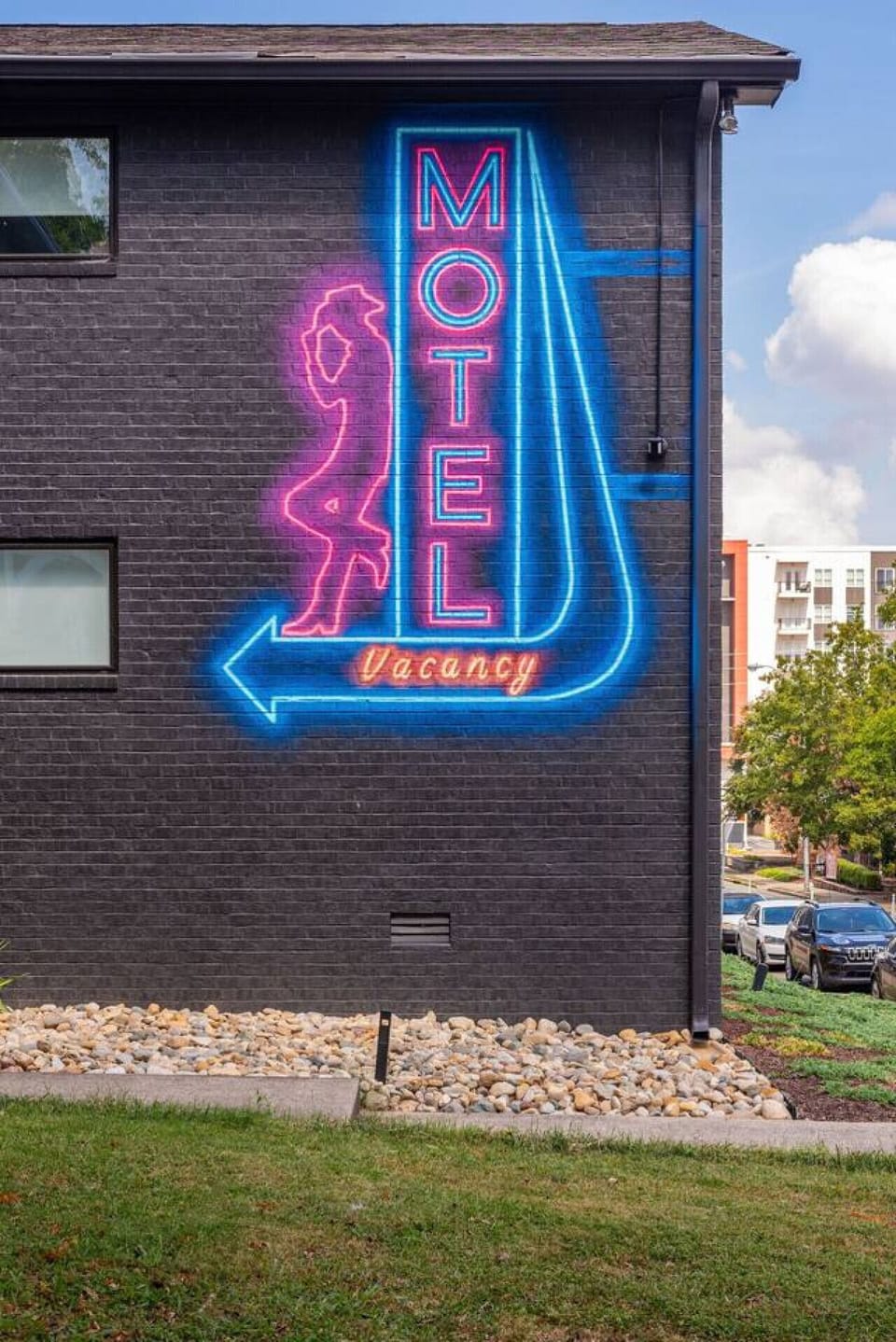 The HOTEL Vacancy neon sign on the building exterior is a bright and iconic welcome to The Lyric.