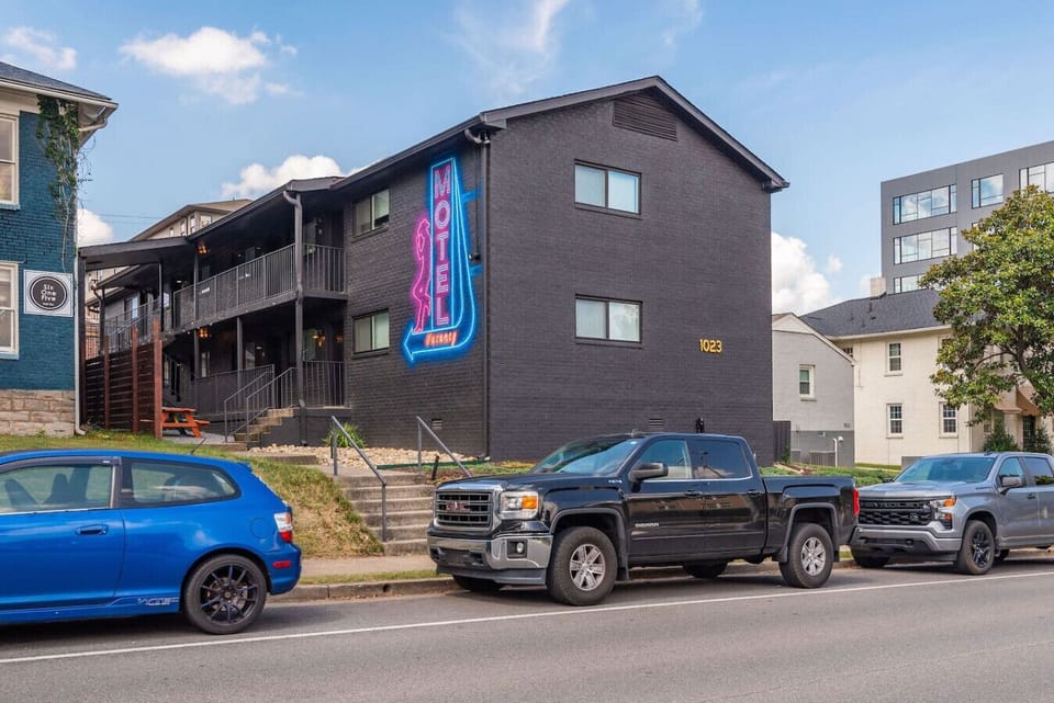 The Lyric on Music Row is a striking dark-sided building with glowing neon signs that welcome you in.