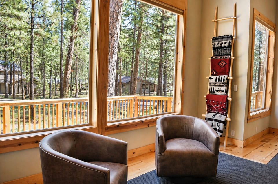 Settle into these cozy leather chairs and let your gaze drift through floor-to-ceiling windows to peaceful forest views.