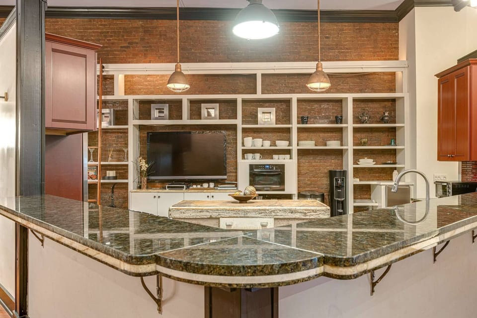 Gourmet kitchen with sleek finishes and views.