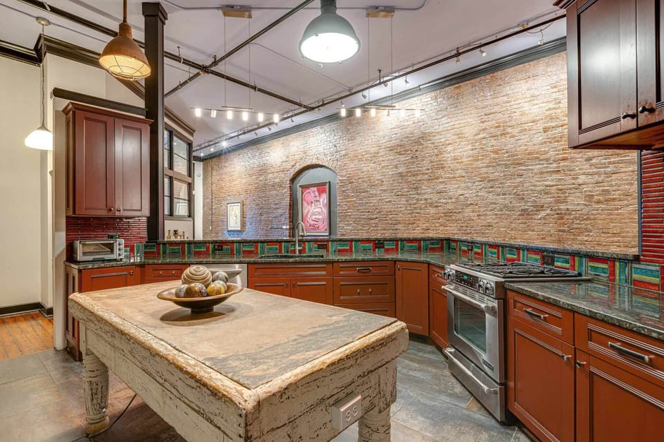 Gourmet kitchen with sleek finishes and views.