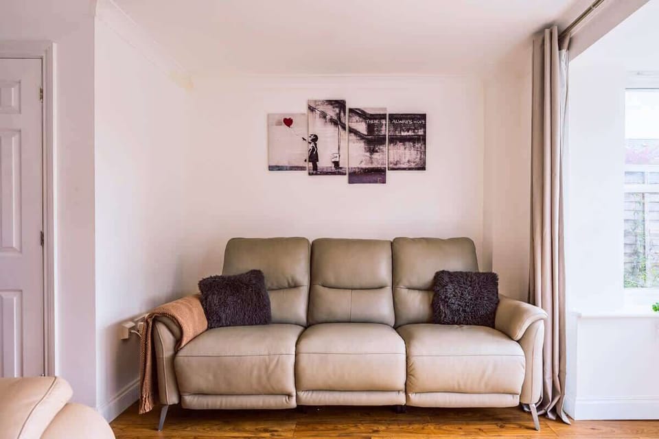 Comfortable leather sofa in minimalist living room with wall art.
