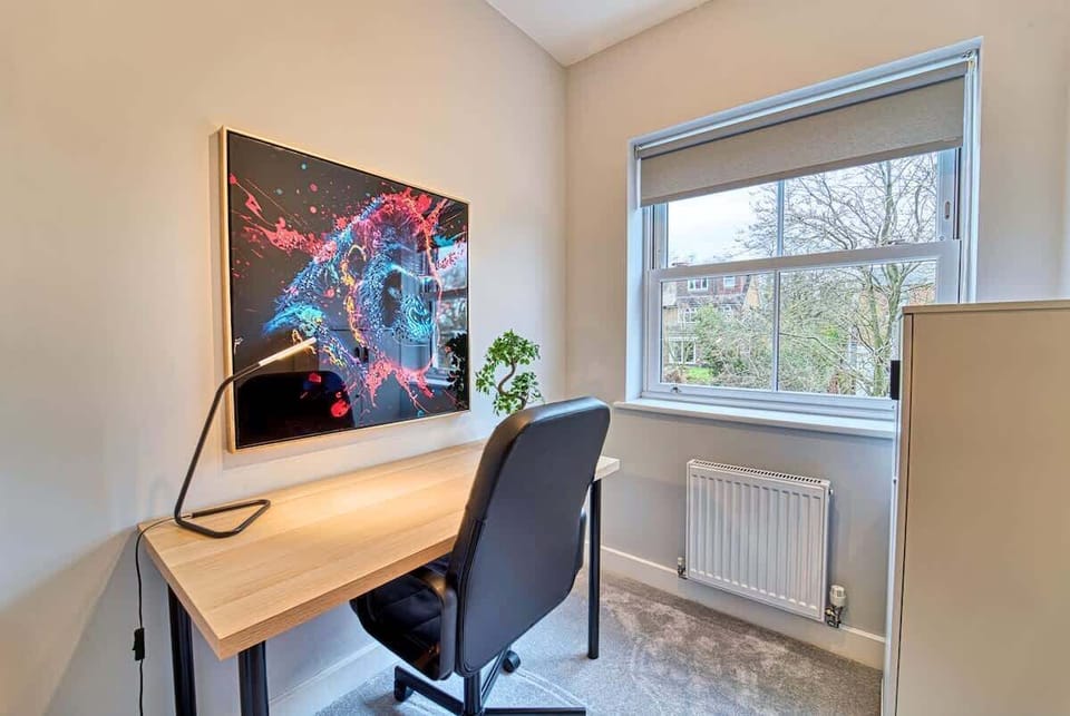 Modern desk workspace colorful wall art bright window minimalist design

