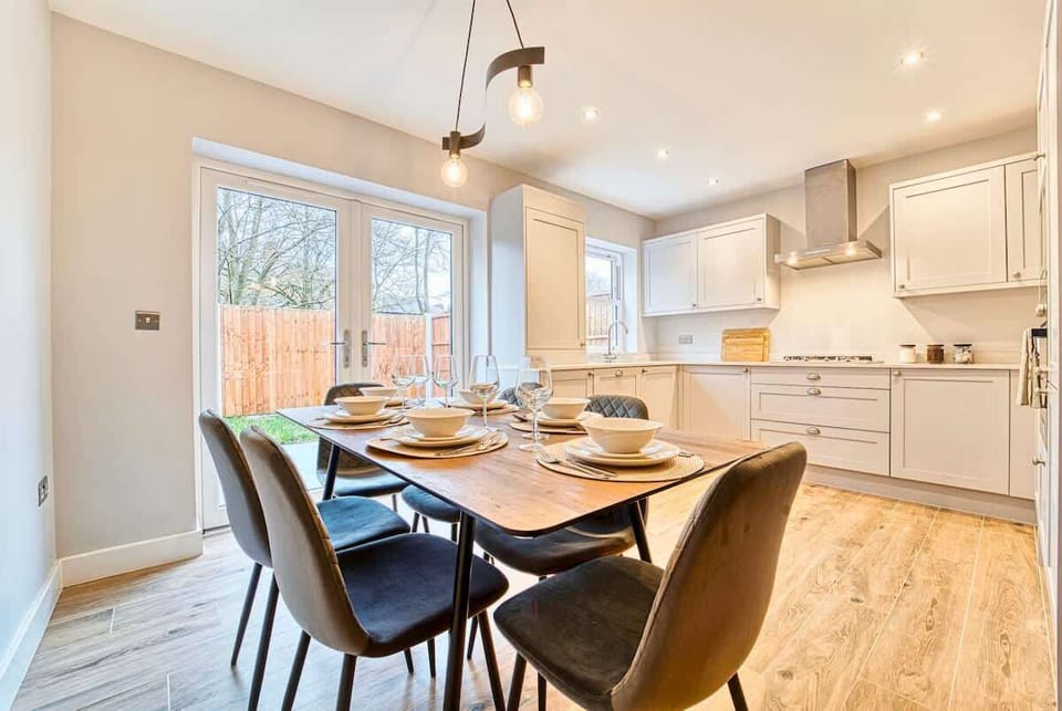 Bright dining area with table, stylish chairs, and natural light.
