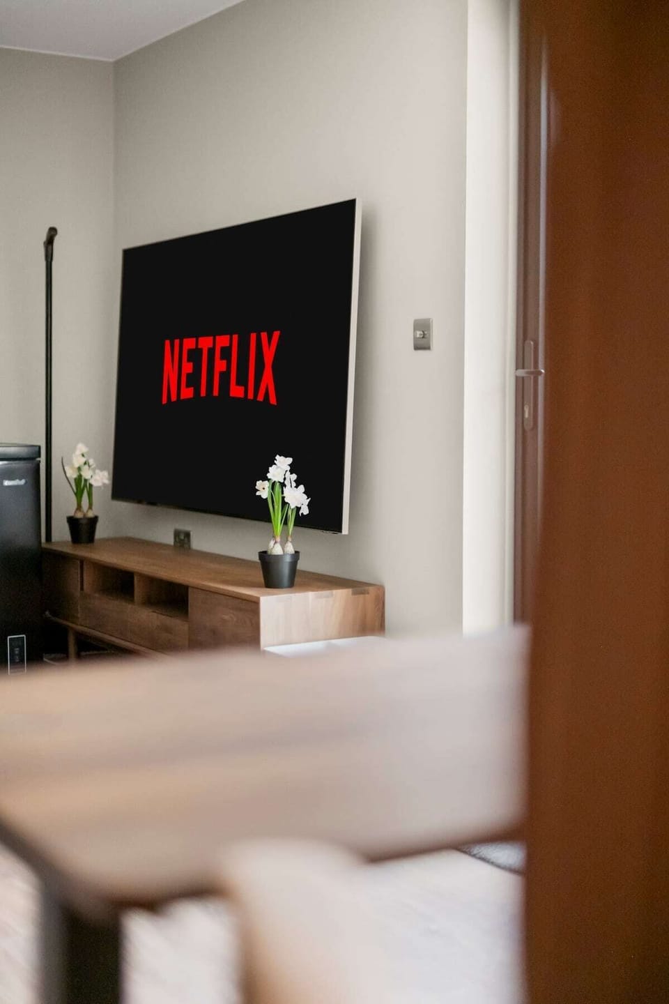 Modern living room with mounted television console and cozy atmosphere