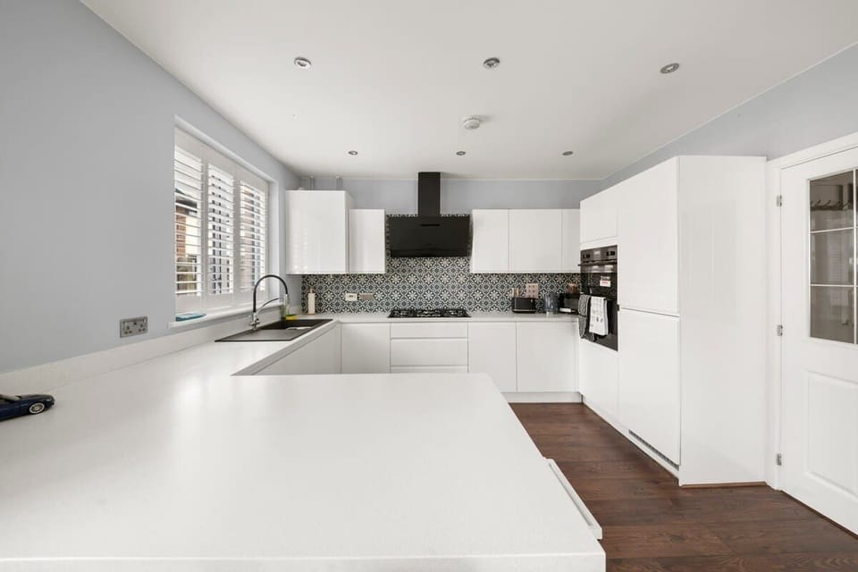 Clean minimalist kitchen with large island and bright lighting
