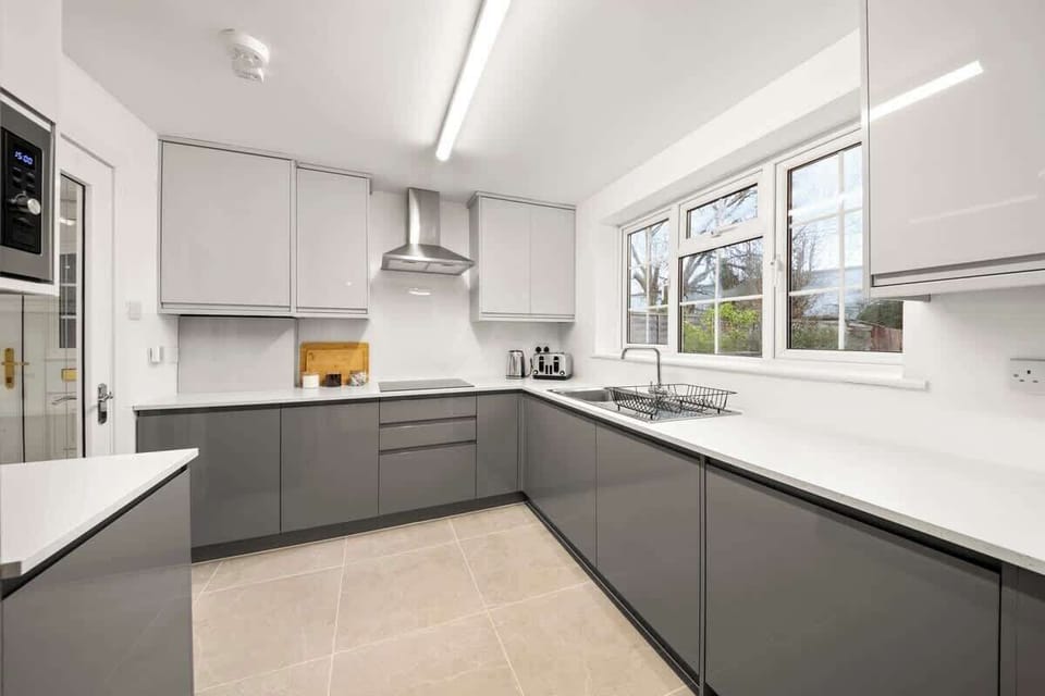 Bright kitchen corner with ample counter space and contemporary cabinetry
