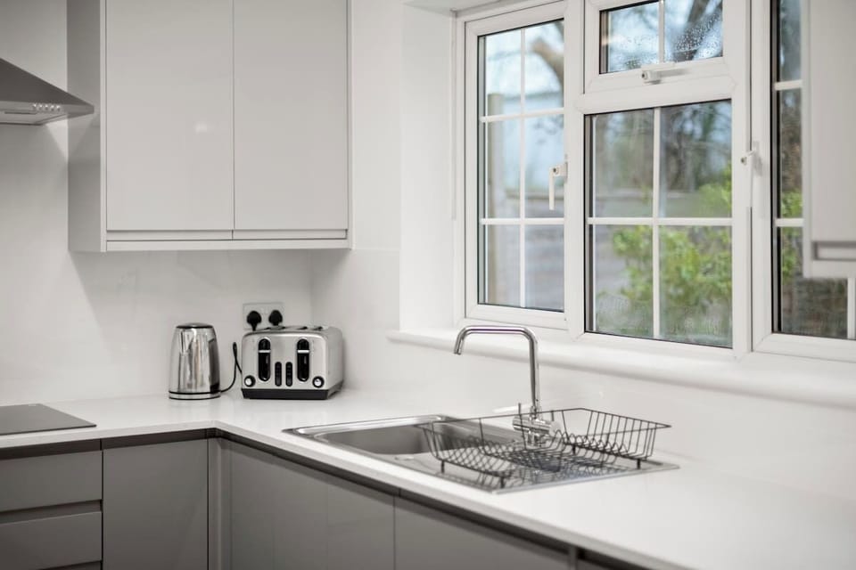 Kitchen sink area with window view and practical countertop workspace
