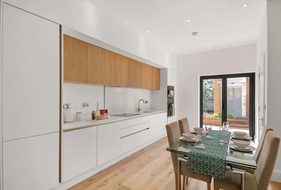 Sleek minimalist kitchen with wooden cabinets and clean white surfaces