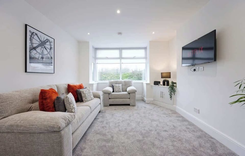 Spacious lounge with soft carpeting and large window natural light