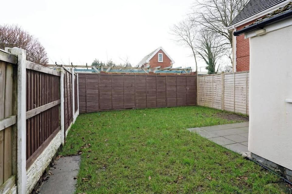 Private backyard space with grass lawn and fenced peaceful surroundings
