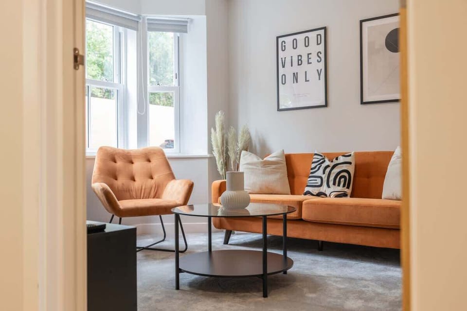 Comfortable lounge area with orange sofa armchair and minimalist decorations