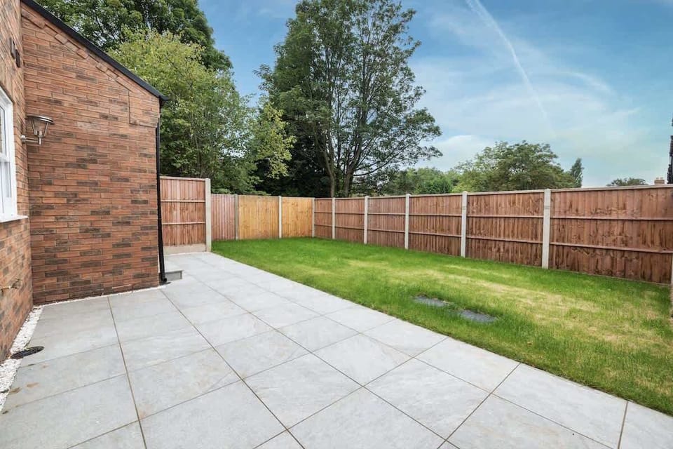 Spacious paved patio and green garden perfect for relaxing outdoors