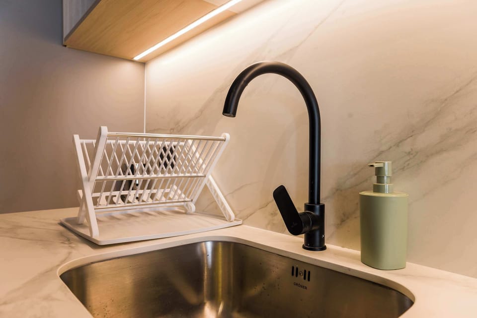 Sleek and modern kitchen setup with a stylish black faucet and marble countertop, perfect for your culinary needs.