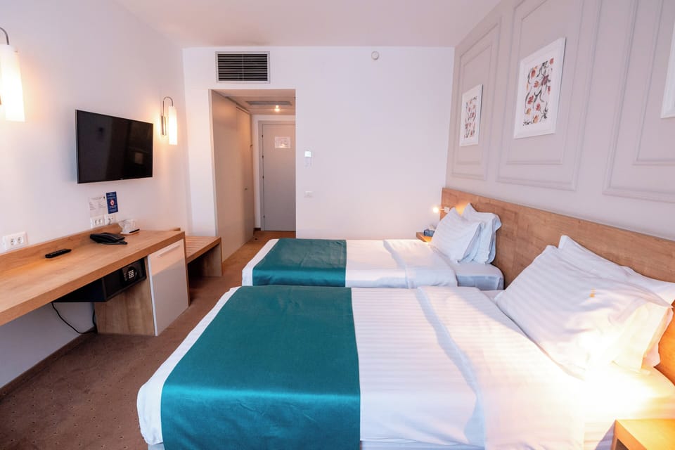 Twin Room | Minibar, in-room safe, desk, iron/ironing board