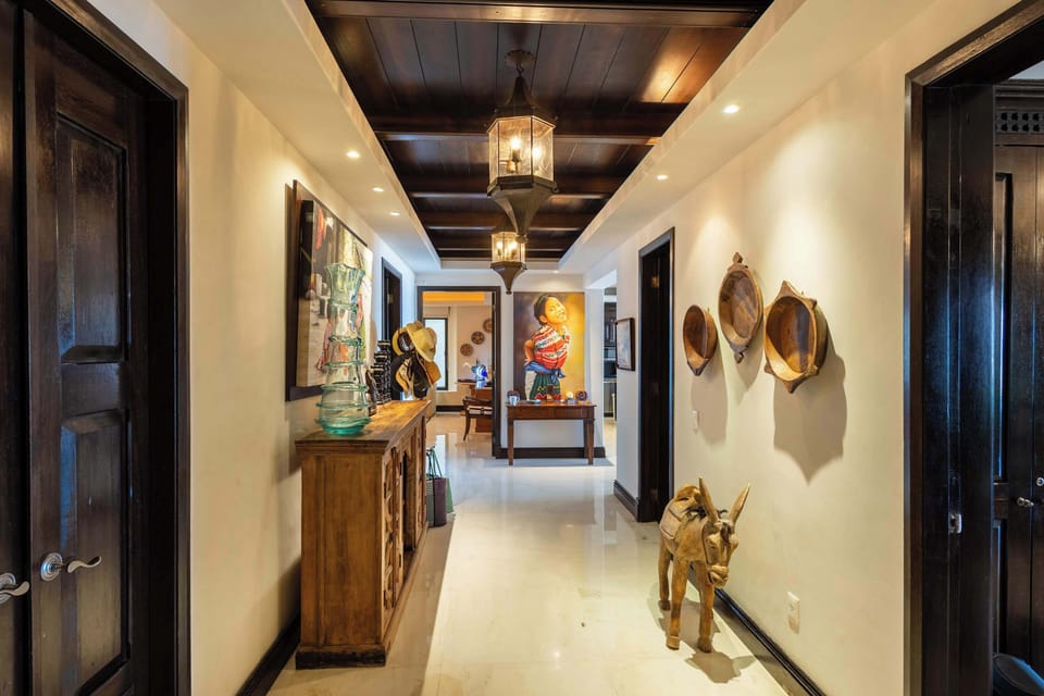 Beautifully designed hallway with curated artwork and warm lighting, creating a welcoming and sophisticated atmosphere throughout the home.