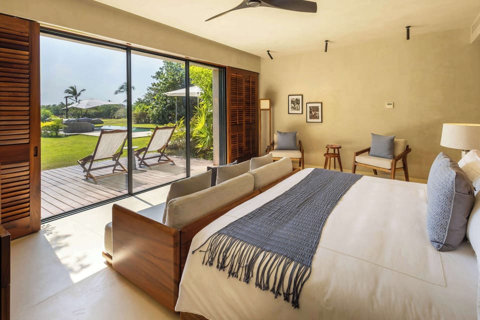 Pool-view master bedroom with king-size bed