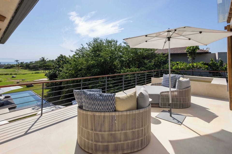 Relax on your private terrace overlooking the pool, complete with plush lounge chairs 