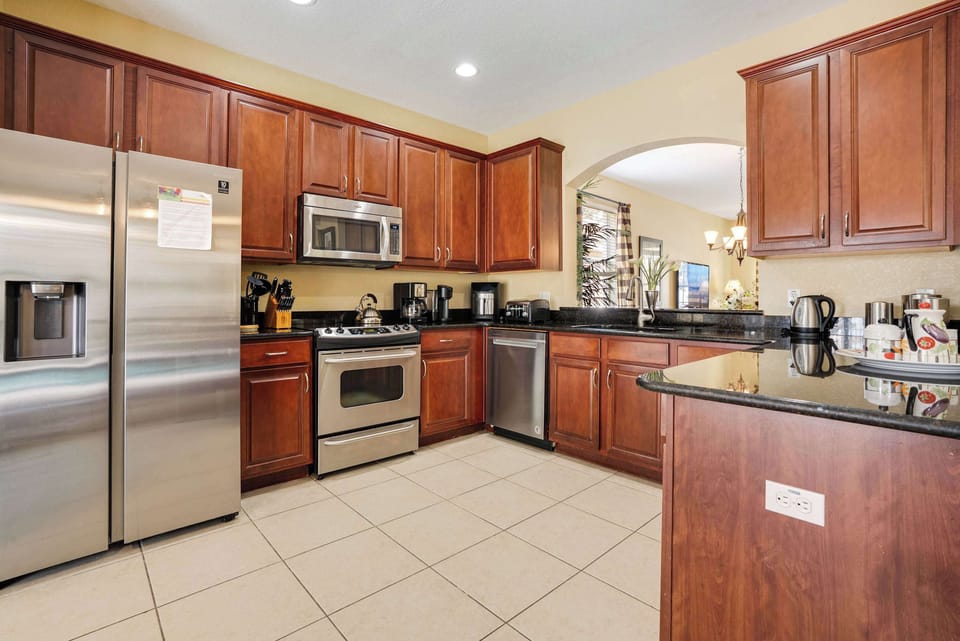 Modern kitchen with stainless steel appliances and rich wood cabinetry