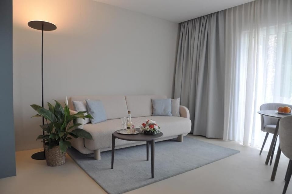 Luxury Suite, Balcony, Lake View | Living area | TV