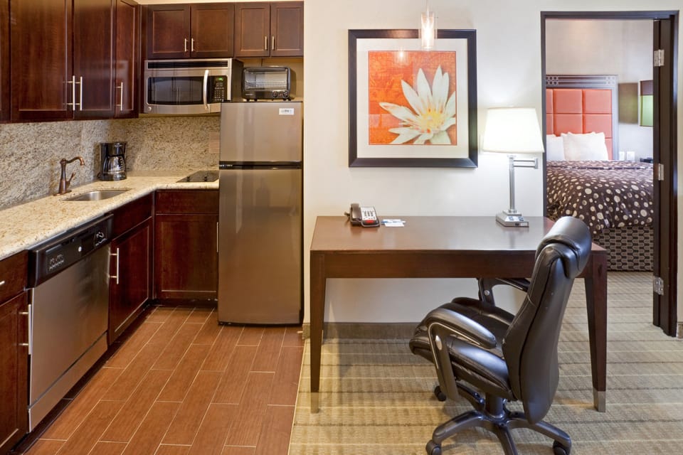 Kitchen with granite countertops and full-size appliances.