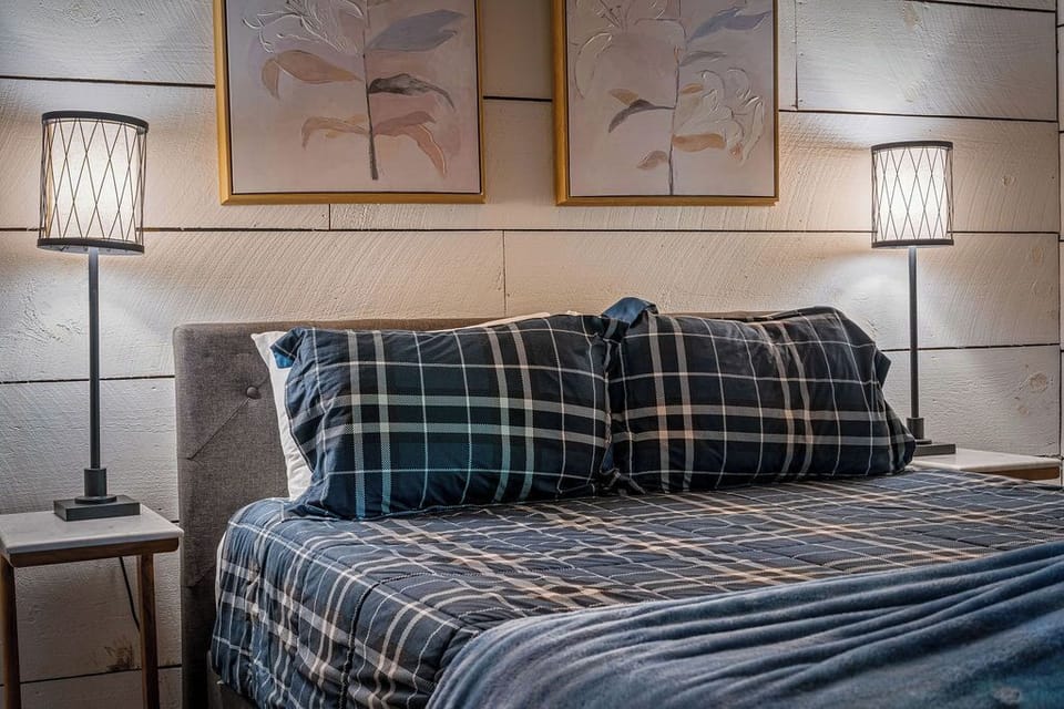A cozy and inviting bedroom designed for restful nights, featuring warm wood accents and soft lighting that create a peaceful atmosphere.