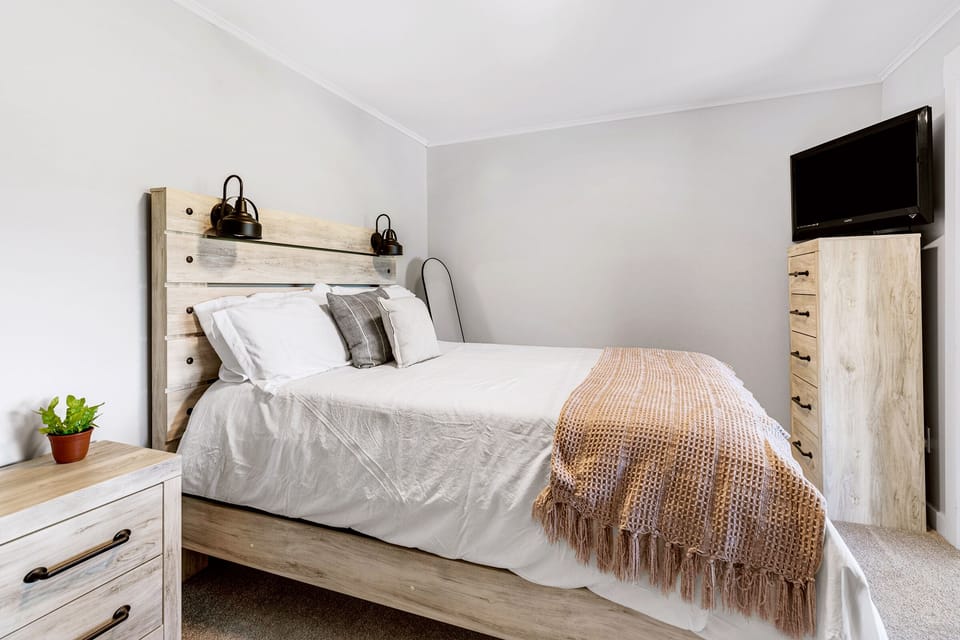 Queen size bed with a smart TV