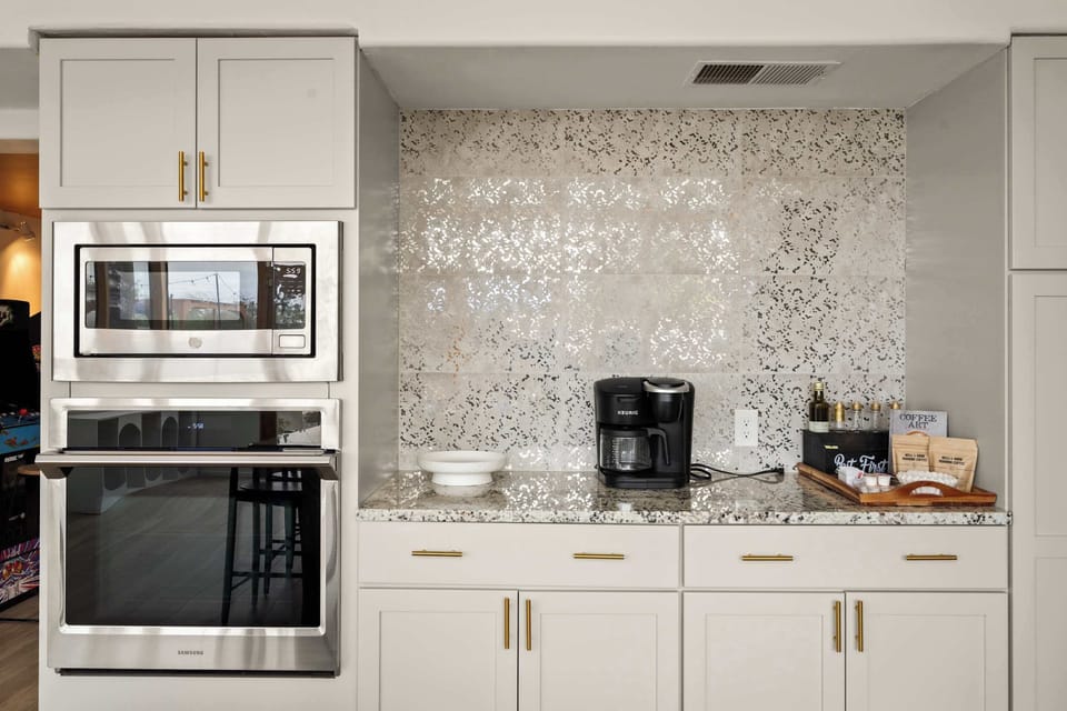 Chef-Worthy Elegance – From the sleek stainless steel double oven and microwave to the stunning mosaic backsplash and granite countertops, this beautifully appointed kitchen station has everything you need to cook, brew, and indulge in style.